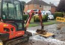 A digger blocks the water leak in Liverpool Road, Ronkswood, Worcester this evening