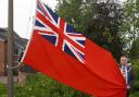 Cllr Robert Raphael, Chairman of Wychavon District Council, raises the Red Ensign.