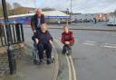 SLOPE: Rae Wood (in the wheelchair) with campaigner  Adam Scott (left) and Tom Collins are concerned by the steep slope and camber at the corner of Union Street and City Walls Road in Worcester