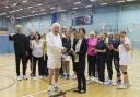 Godfrey Harvey (front left) receiving his award from Dr Susie Hart. Pictured with the seniors badminton programme.