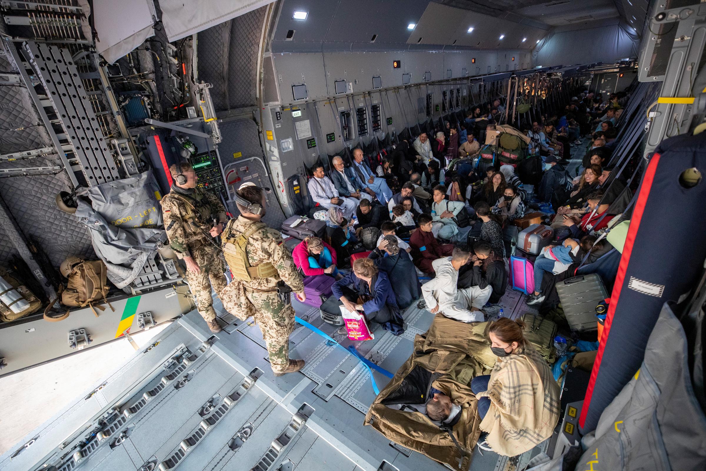 EVACUATED: Evacuees from Kabul sit inside a military aircraft as they arrive at Tashkent Airport in Uzbekistan. Picture: Marc Tessensohn/Bundeswehr via Getty Images