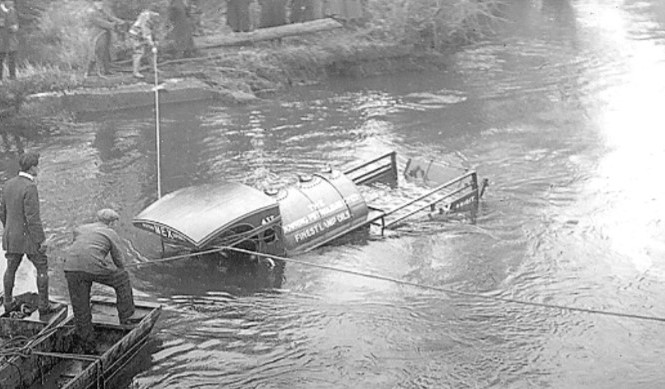 A scene from a tragedy which occurred at the Bransford Old Bridge almost 101 years ago. The driver of the tanker lorry and his daughter were drowned when the vehicle plunged off the road into the Teme 