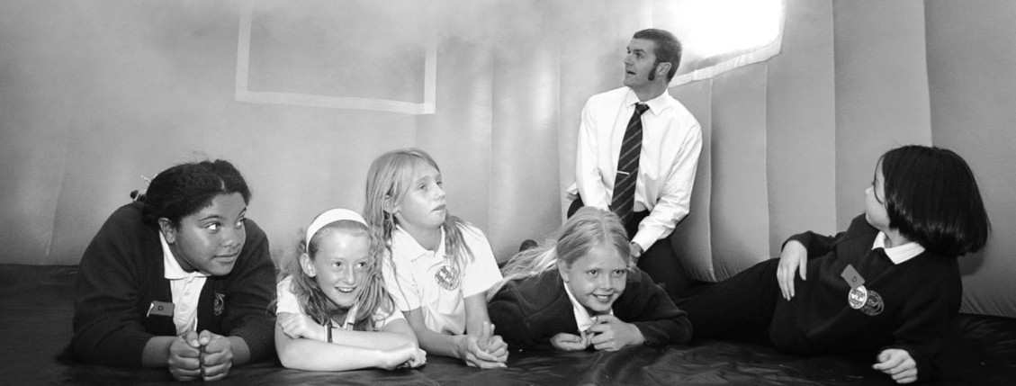 Lie low and stay low: Gorse Hill Primary School teacher Mark Ridlington shows the best way of reacting when a fire breaks out and choking smoke fills a room in September 2006. With him are, from the left, Danielle Murray, Meg Simpson, Chloe Evans, Amy