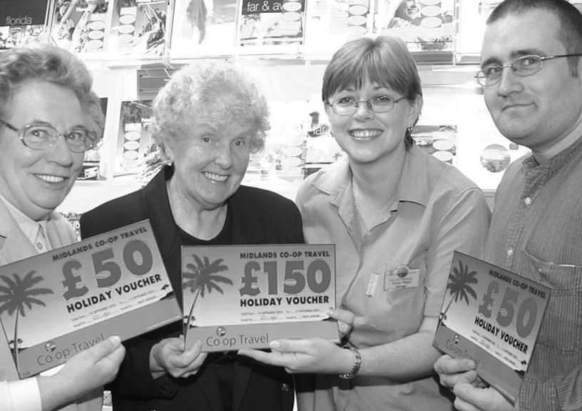 Anna Reed, manager of the Midlands Co-op Travel Shop presents the holiday vouchers to Evening News winners Phyllis Handy, Mavis Senter and Einstein Ellis in September 2002 after they won a Co-op Travel competition to celebrate moving into its new shop in