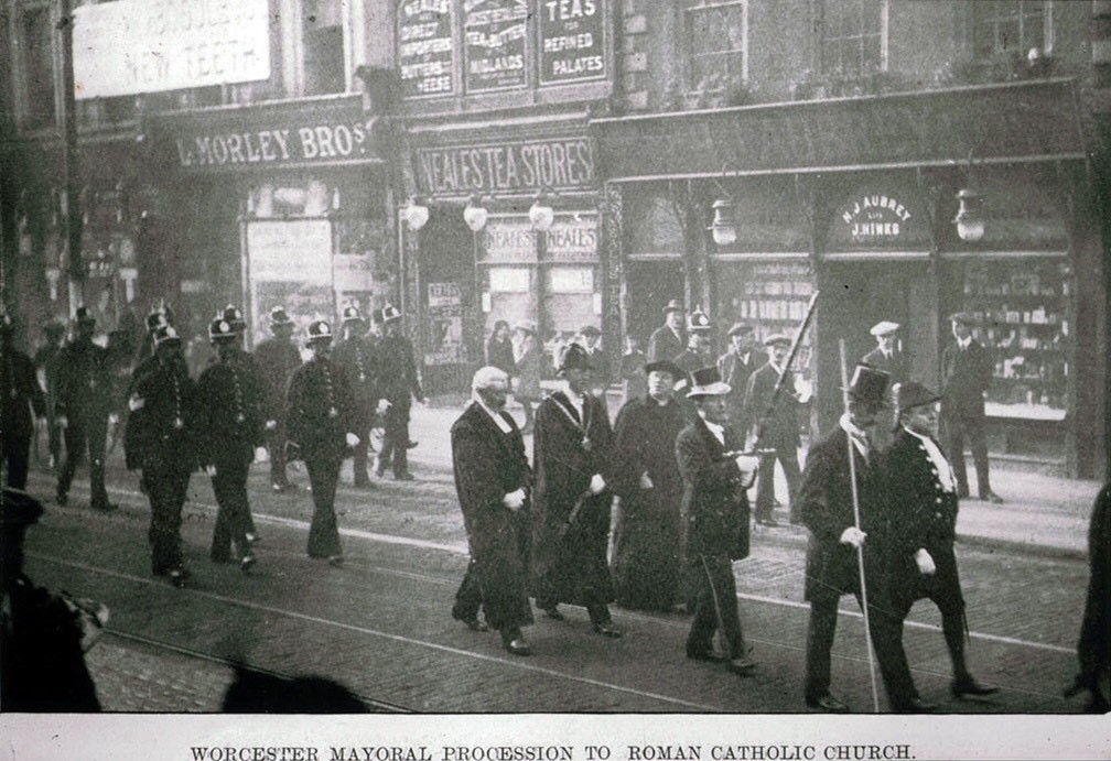 A mayoral procession through Worcester in the early 1900s passes one of the Morley shops