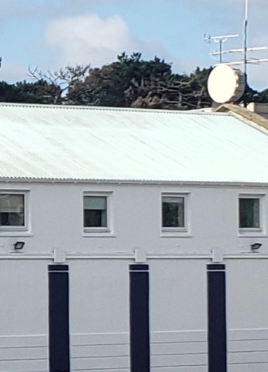 Three blue stripes on the side of this building. But where is it?