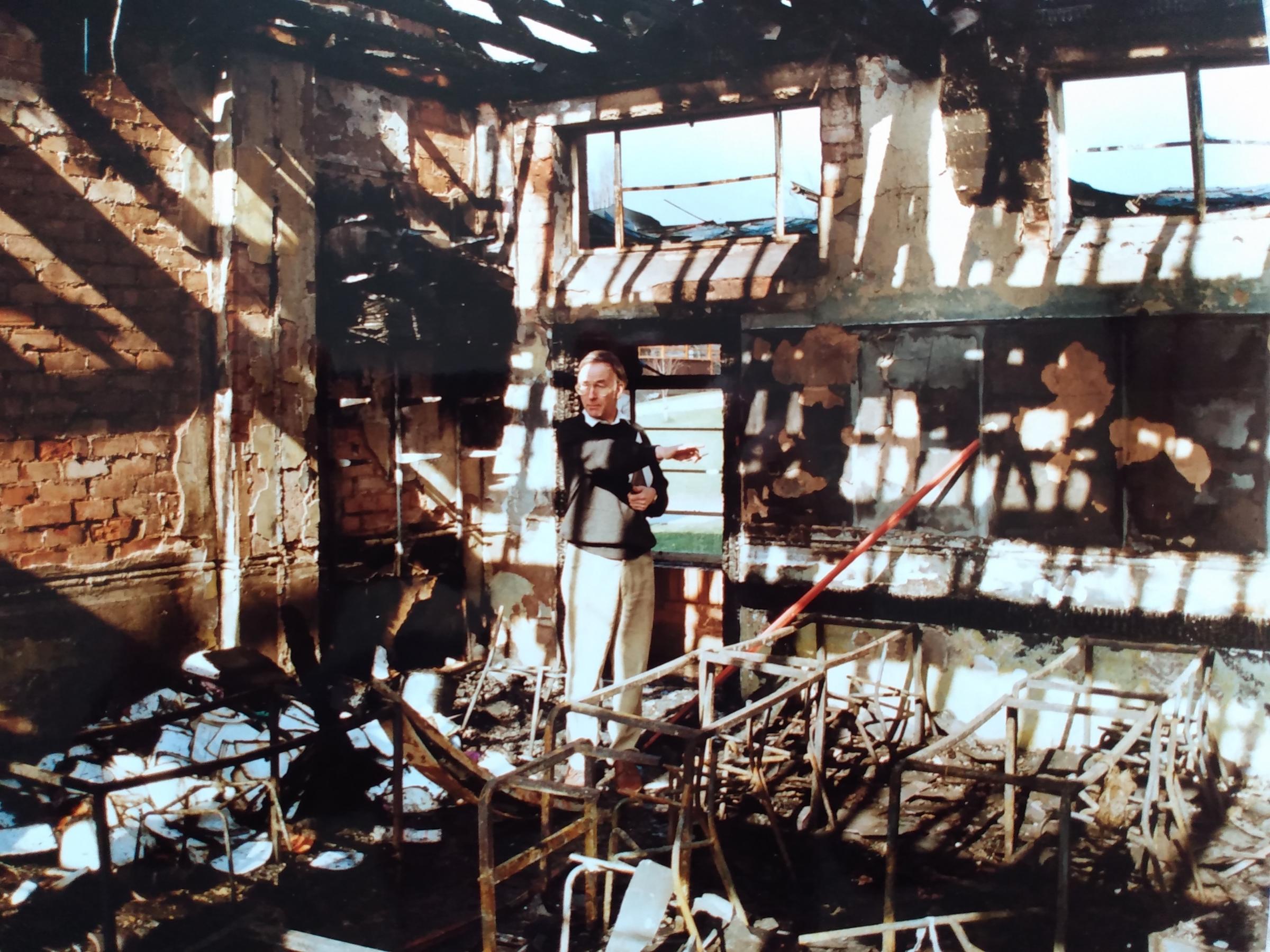 Headmaster Roger Tringham surveys the damage to the school’s maths block in March 1993 after a fire