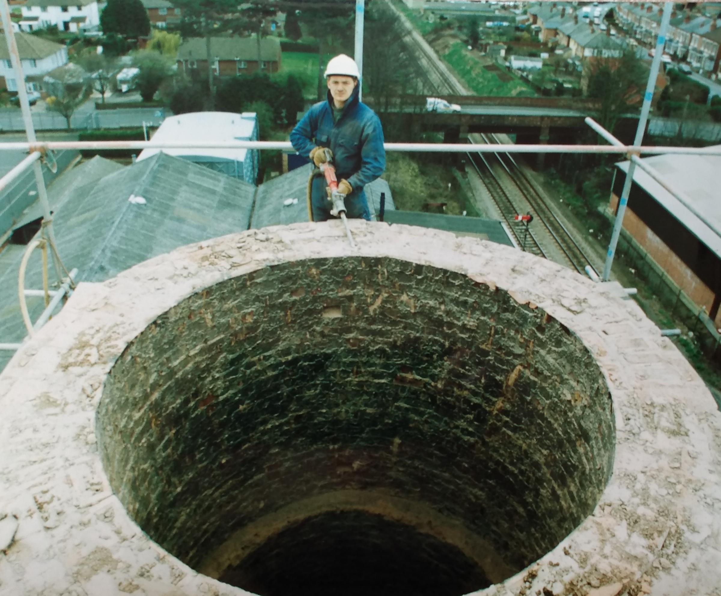 Mike Bent starts demolition work, brick by brick, on the chimney in March 1998 in a bid to improve the local environment