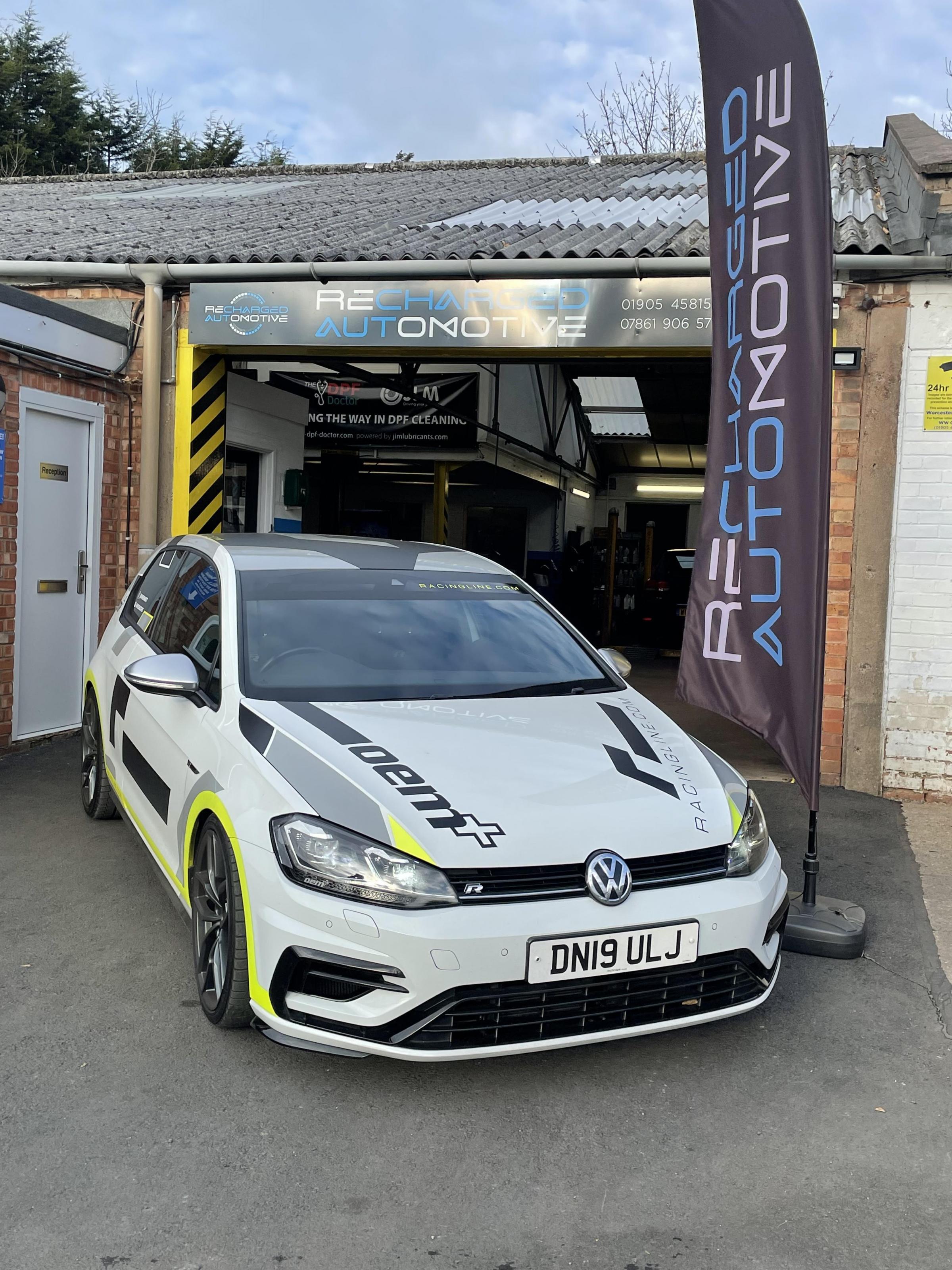 Workshop frontage with an immaculate racing line performance VW Golf