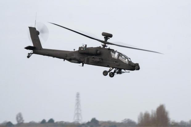 An Apache AH-64E helicopter conducting a test flight