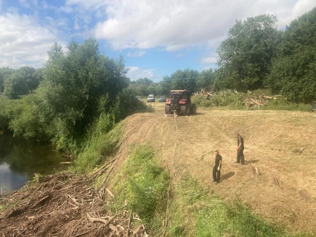 Worcester News: HEAVY: This big tractor is the ideal piece of kit for dragging all the debris out of the River Teme. Photo: James Connell
