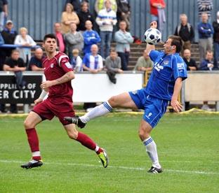 Mike Symons takes the full force of the ball.