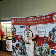 Andy Walters shows off his national indoor singles trophy