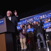 Democratic presidential candidate, Sen. Bernie Sanders, I-Vt. waves to the crowd during a campaign stop at The Colonial Theatre, Tuesday, Feb. 2, 2016, in Keene, N.H. (AP Photo/John Minchillo).