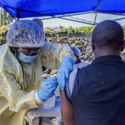 A man receives a vaccine against Ebola from a nurse outside the Afia Himbi Health Center on July 15, 2019 in Goma. - Authorities in Democratic Republic of Congo have appealed for calm after a preacher fell ill with Ebola in the eastern city of Goma, the