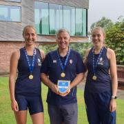 CHAMPIONS: Georgie Thorp (left) and Alice Baker (right) alongside coach Will Bird after winning gold at the British Rowing Championships.