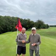 HOLE IN ONE: Warren McDivitt congratulating Bob Matthews (pictured on Right) on his remarkable achievement