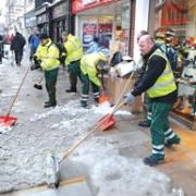 SHOVELS: City council workers clear the High Street (51170007)