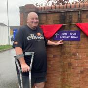 FINISH: Nick Cook also known as 'Big Bear gets his sign' showing the way to his Cranham Drive bungalow