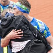 Kevin Sinfield carries Rob Burrow over the finish line at the marathon