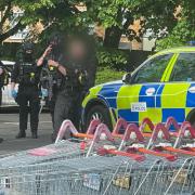 POLICE: An eyewitness captured this image of police holding a sword at Sainsbury's Blackpole.