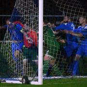 News: Pershore Town's Kirk Layton appears to be hit by one of the Coton Green replacements.