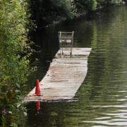 STRANGE: A pontoon with a traffic cone and a shopping trolley has been pictured floating down the River Severn.