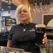Feathers general manager Jade Colquitt with a £2 pint of Guinness