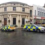 Police cars block the entrance to Church Street in Malvern after the incident