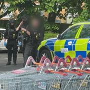 POLICE: An eyewitness captured this image of police outside the supermarket