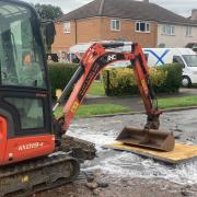 A digger blocks the water leak in Liverpool Road, Ronkswood, Worcester this evening