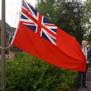 Cllr Robert Raphael, Chairman of Wychavon District Council, raises the Red Ensign.