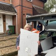 AFTERMATH: Property manager Jill holds the remains of a door chainsawed by police during a raid by armed police in Hock Coppice in Warndon Villages