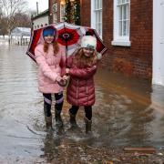 Children take a walk in a soggy South Quay in Worcester