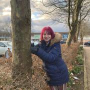 VICTORY: Cllr Jill Desayrah hugs a tree - she says the decision to withdraw the application for a drive thru coffee shop, rumoured to be a Starbucks, is a victory for all the residents who had campaigned against it