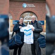 Charlotte Beauman-Evans, senior lecturer in physical education at the university, handed over 100 pieces of unused kits to regional collector for SOS Kit Aid Mark Newton