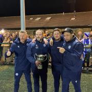 Worcester City management team celebrate with the trophy