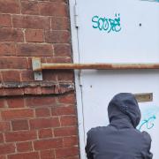 Youth cleans up his graffiti