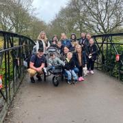Henry Parry, pictured in his pushchair and walking inset, with his father Ryan Parry and mother Emily Martin along with brother Alfie, three, Maggie, six, and Marnie, nine. Back row: Molly Parry, April Mathews, Sally Saunders, Billy Dighton, Laura Parry