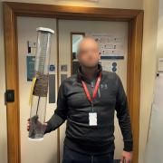 RESULT: A detective holds the sword-like machete seized as part of a raid in Saddlers Walk in Worcester on Tuesday