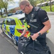 SEIZED: Police seize the Nottingham Knocker's bag in Malvern