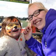 12158448012. 21/03/15. Left to right - Yasmin Poyner aged 2 has her face painted by Kelly Teague. Charity MS football fun day at the KGV Community Centre in memory of Joey Gormley. Picture by Nick Toogood. (21246733)