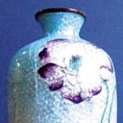 This vase may look robust but the pattern is actually very delicate. It is made up of fired glass beads that are kept in place by fragile metal wire and can easily bruise.