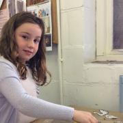 COMPETITION: Heidi, aged eight, working on her ceramic plate for the art competition.