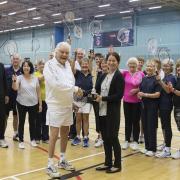 Godfrey Harvey (front left) receiving his award from Dr Susie Hart. Pictured with the seniors badminton programme.