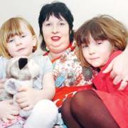 SO BRAVE: Dawn Pless with daughters Imogen, aged three, and, right, Camille, six. Picture: Nick Toogood. 11165401