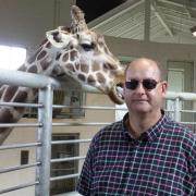 FRIENDS: Rev Canon Matthew Baynes with his favourite animal, a giraffe