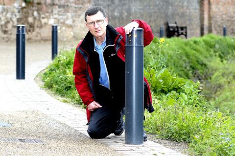 WORRY: Mike Arnold with the bollards by the river Severn.