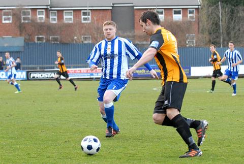 CHARGING DOWN: Worcester City’s Matt Birley (left) tries to win the ball back against Boston.