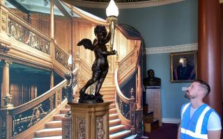 FASCINATION: Director Tom Rudderham next to the replica of Titanic's staircase cherub